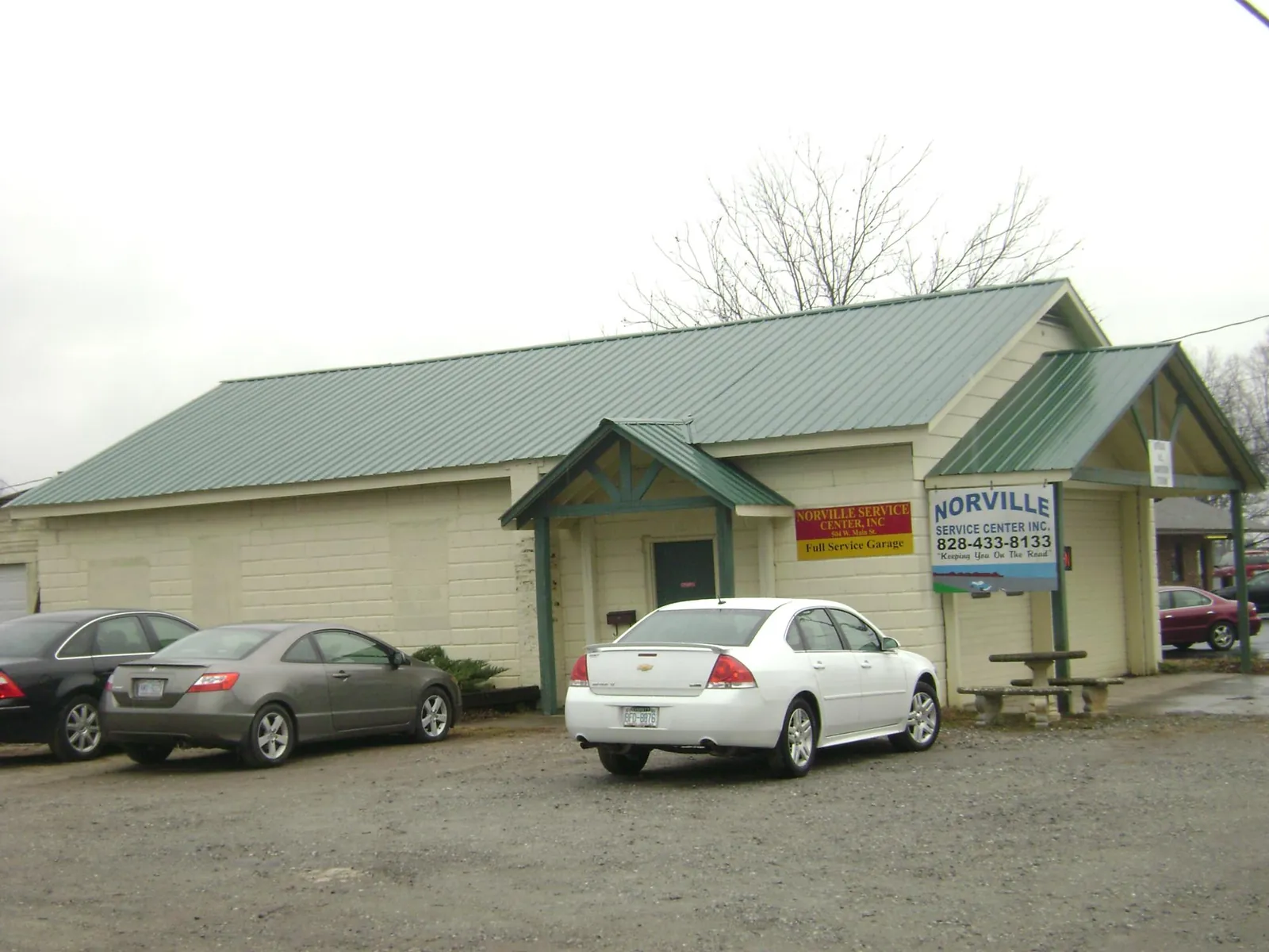 Green metal roof on a service garage with a covered entry in Waynesburg
